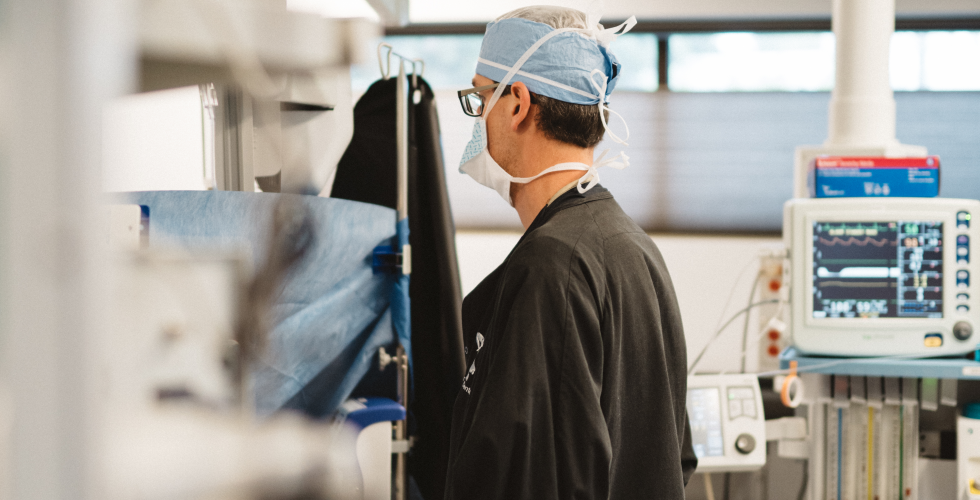 Ophthalmologist monitoring surgery patient